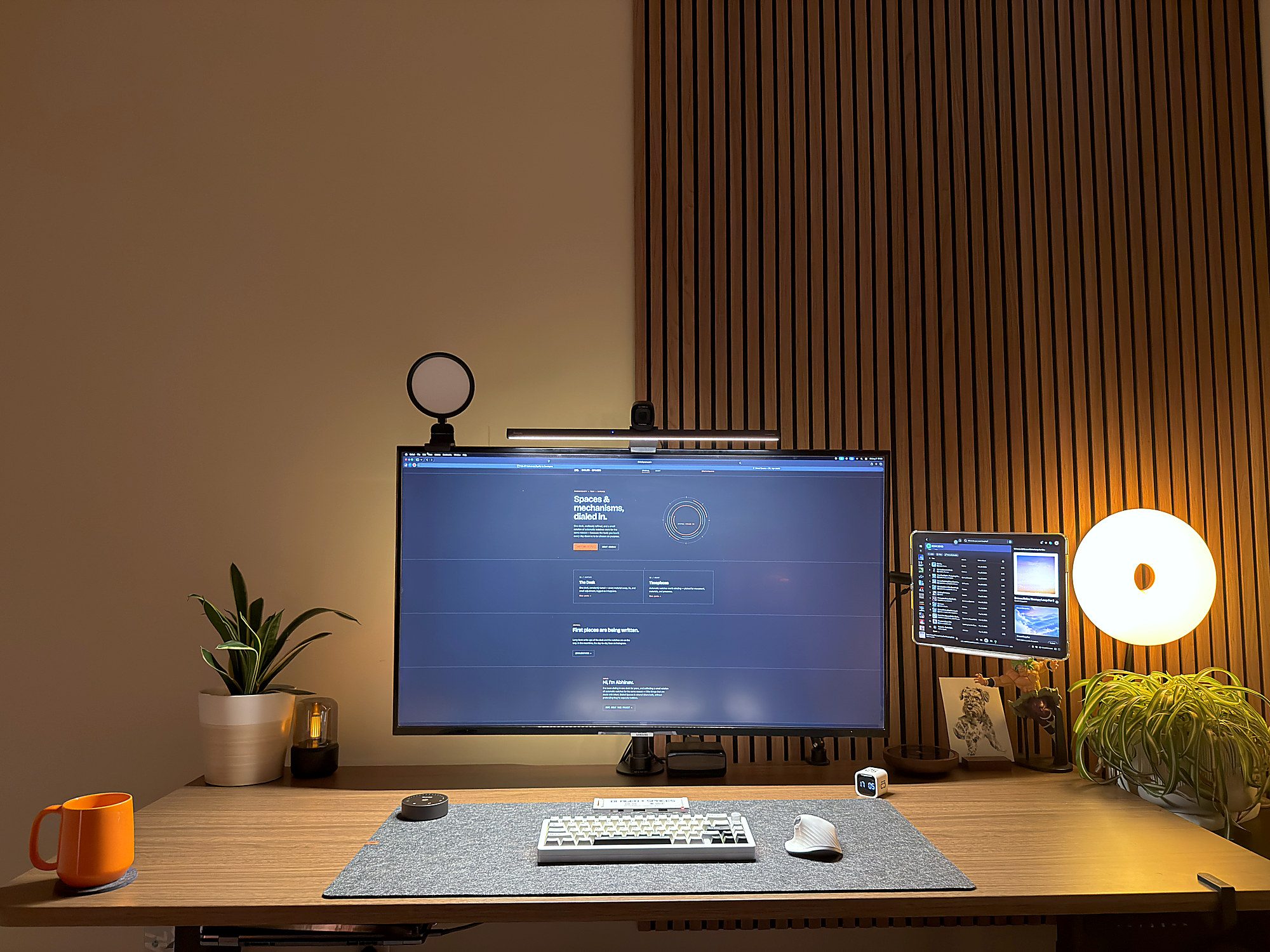 43-inch Samsung 4K TV used as a computer monitor on a standing desk, with an iPad mounted beside it as a second display