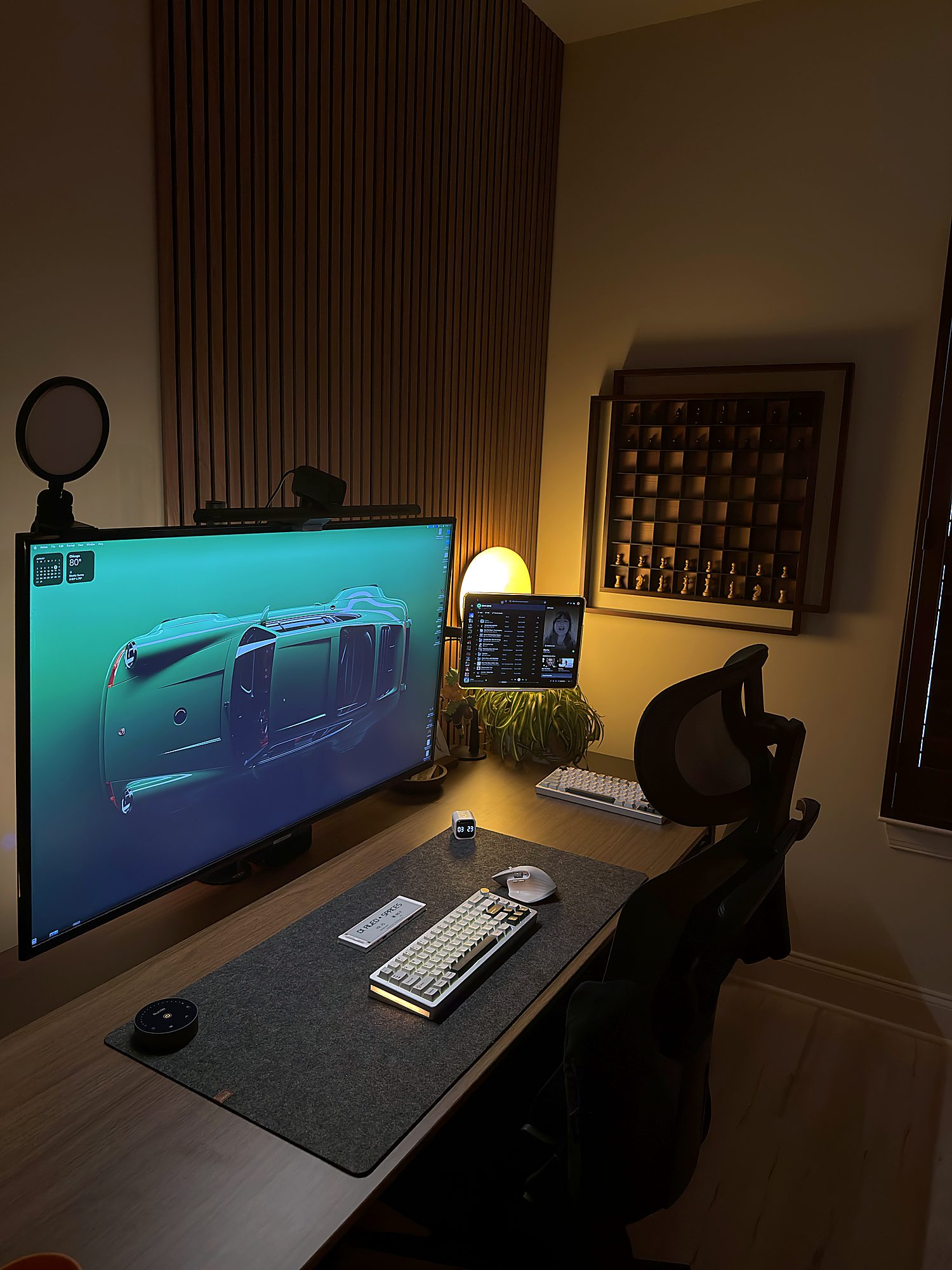 Work from home desk setup with a 43-inch 4K TV used as a monitor, iPad as a second screen, mechanical keyboard and warm desk lamp